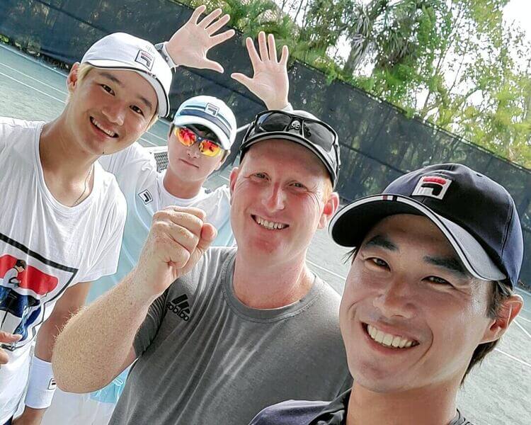 Todd together with professional Tennis players on the court